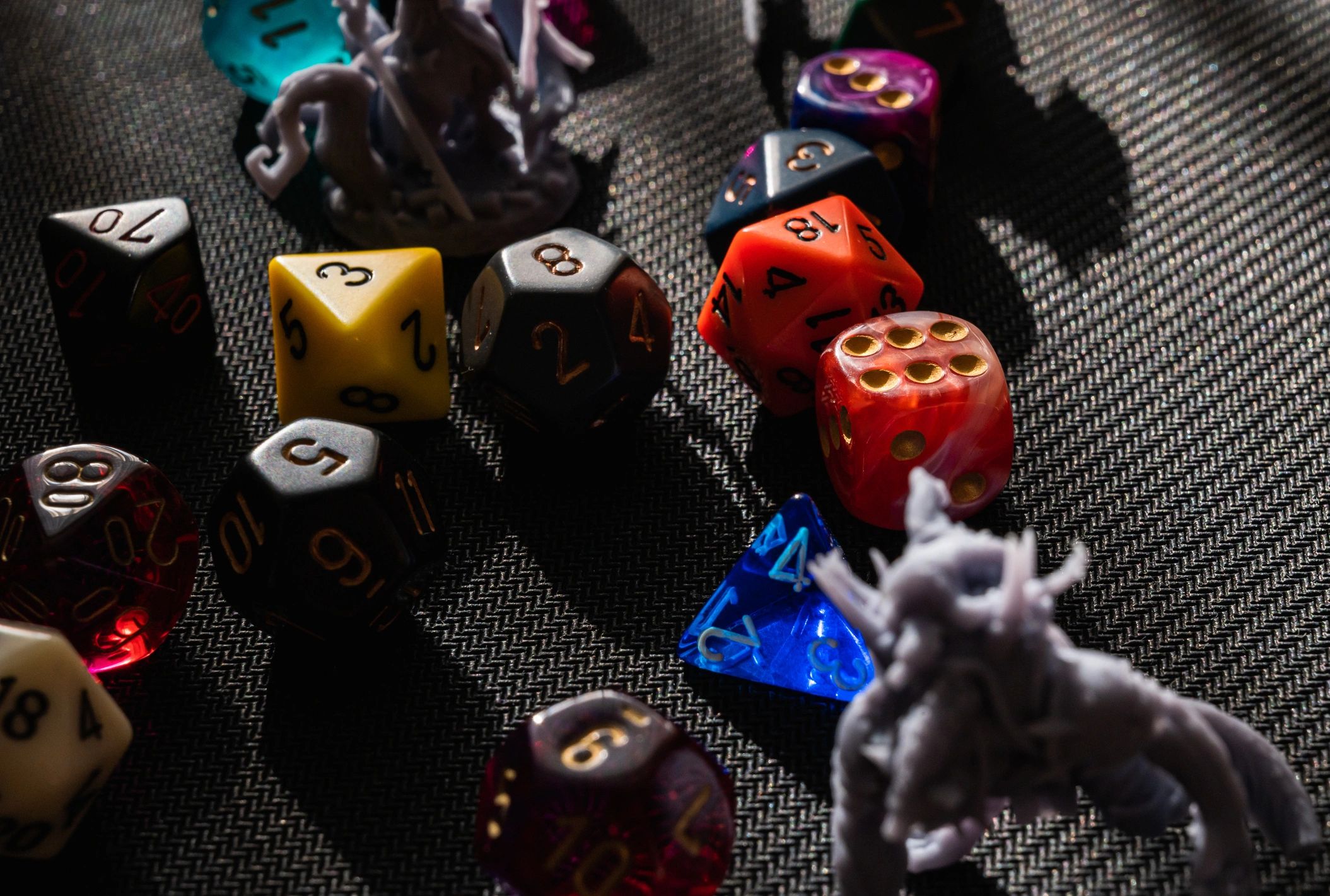 RPG miniatures and dice in dramatic lighting