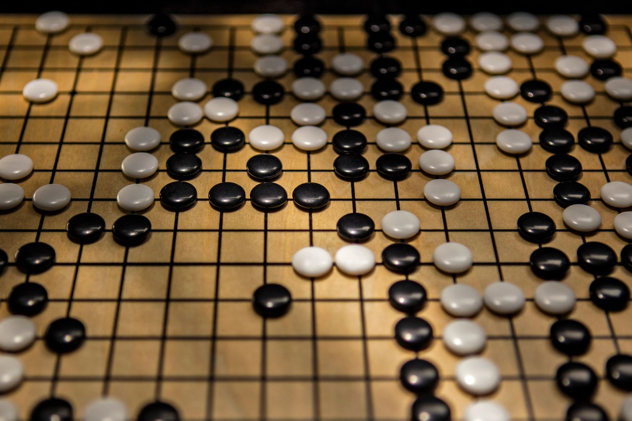 Game board in progress with stones and grid